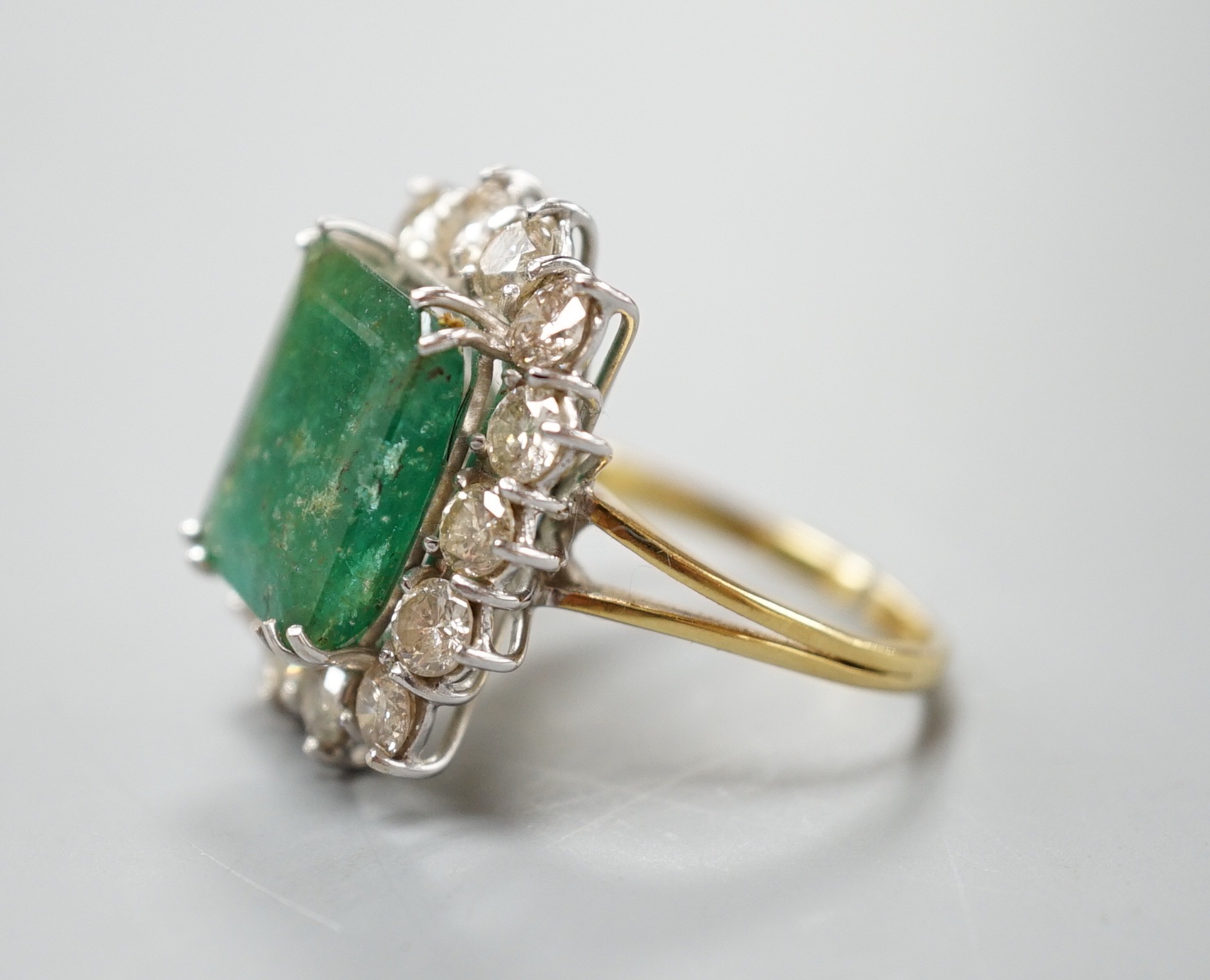 A yellow metal, emerald and diamond set rectangular cluster ring (shank cut), size M, gross weight 7.9 grams